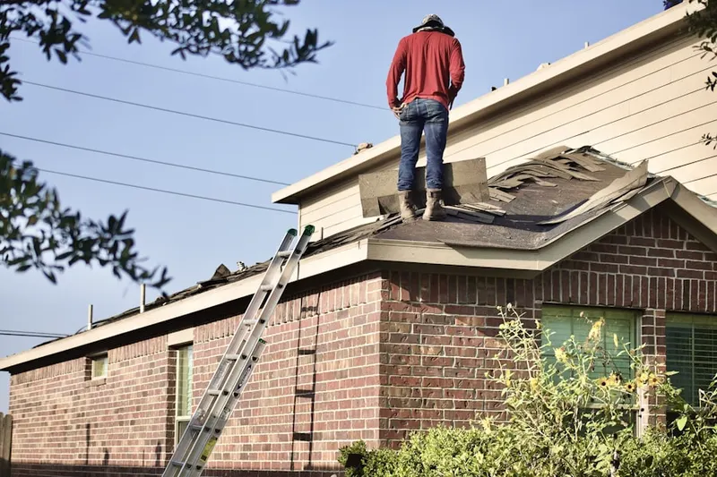Professional roofer working on a residential roof in Hillside Village